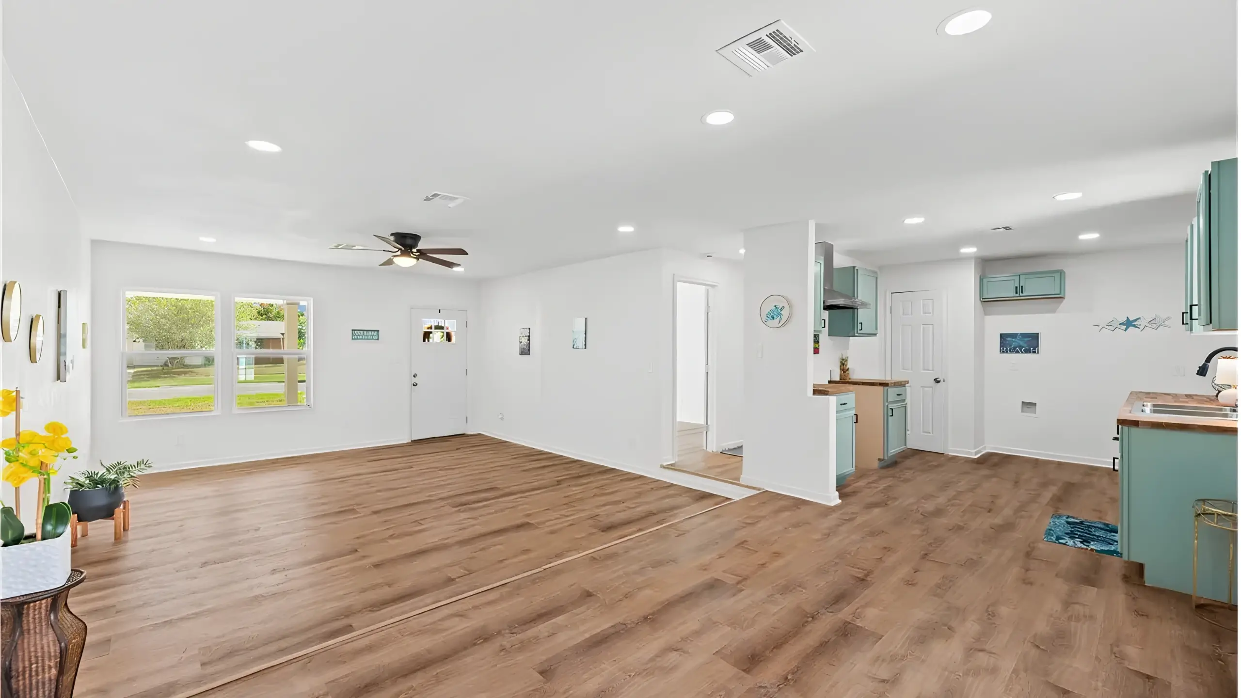 Living room repaired drywall, lighting, painting, clean, trim, doors, windows, cabinets, counters, staged