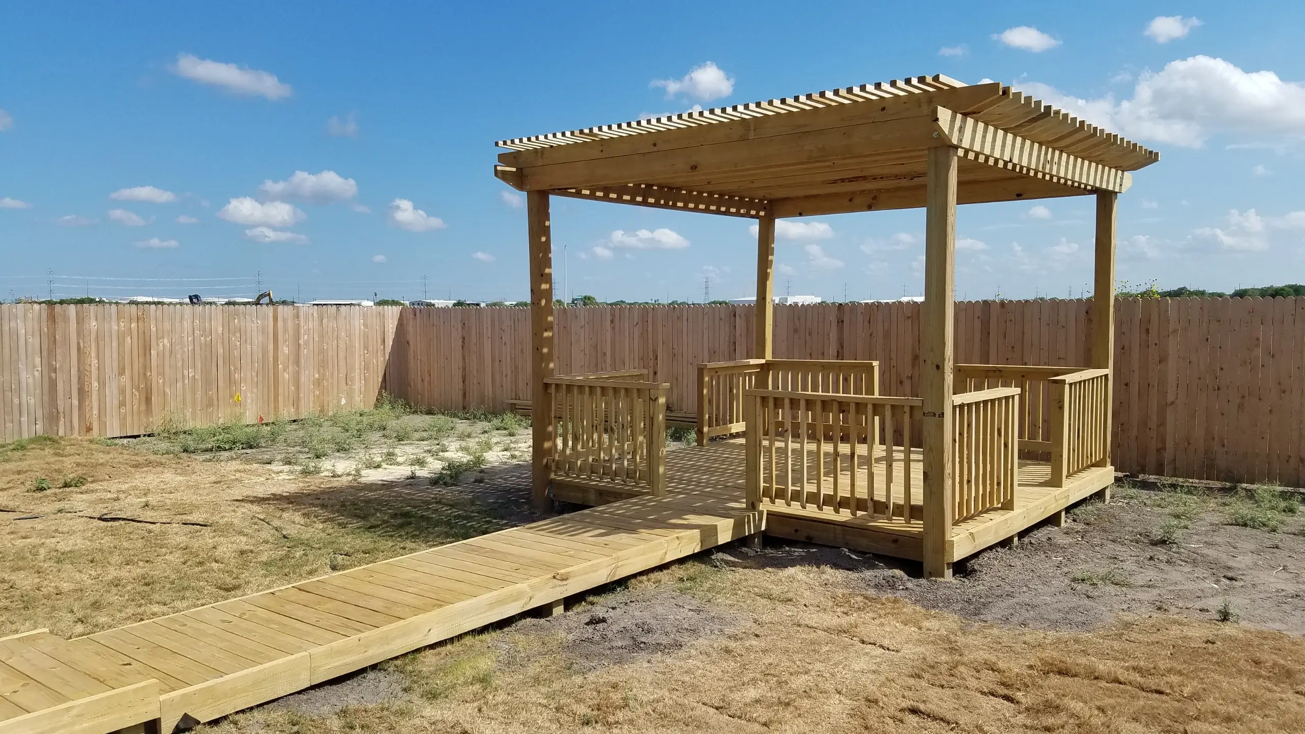 New build empty backyard - new pergola, ground level deck, ground level walkway, railing